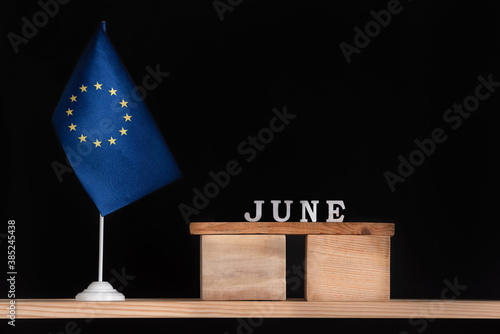 Wooden calendar of June with flag EU on black background. Holidays of European Union in June