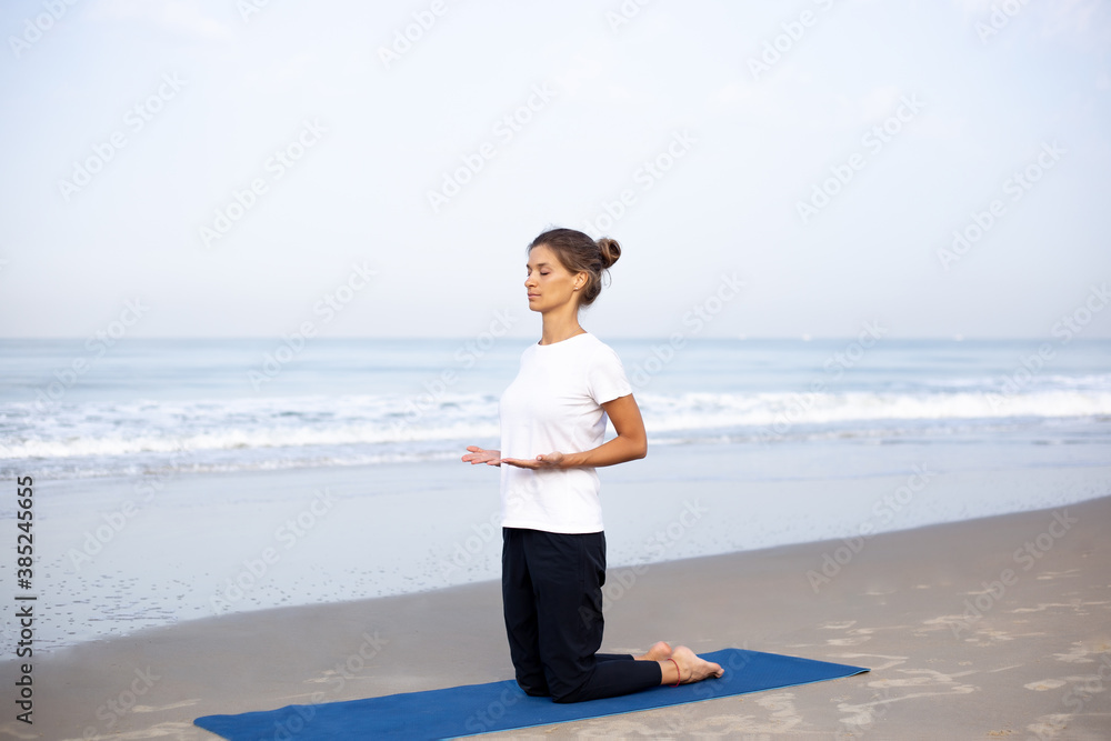 young girl on the beach doing yoga young girl on the beach doing yoga