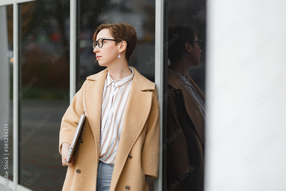Young attractive girl with laptop walking in the city Young attractive girl with laptop walking in the city