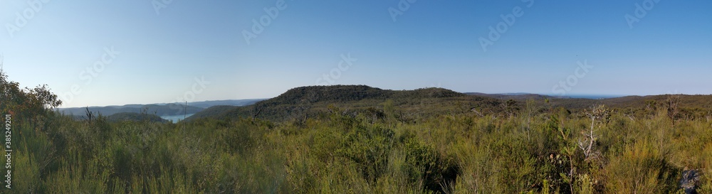 Beautiful afternoon panoramic view of mountain ranges, trees and deep blue sky from a trail, Willunga Trig Point Trail, Ku-ring-gai Chase National Park, Sydney, New South Wales, Australia
