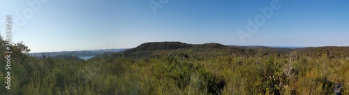 Beautiful afternoon panoramic view of mountain ranges, trees and deep blue sky from a trail, Willunga Trig Point Trail, Ku-ring-gai Chase National Park, Sydney, New South Wales, Australia 