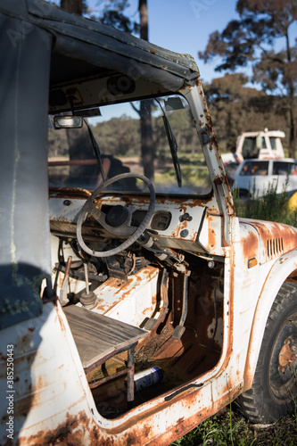 Old rusty car ute on a farm