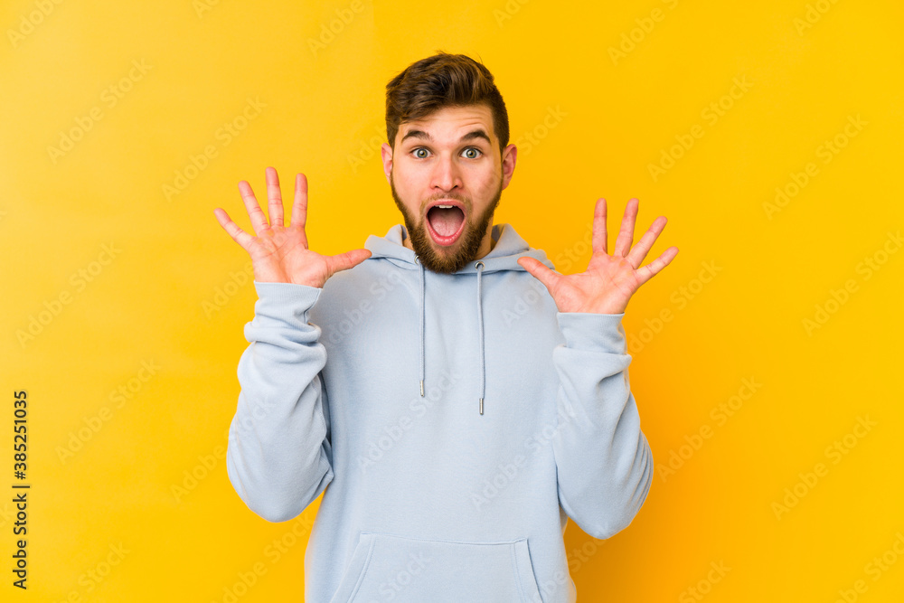 Young caucasian man isolated on yellow background screaming to the sky, looking up, frustrated. Young caucasian man isolated on yellow background screaming to the sky, looking up, frustrated.