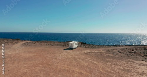 Aerial view. Camper van on a parking lot on a rock near the atlantic ocean. RV park.