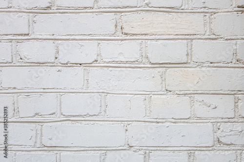 abstract background of an old brick wall painted white close up