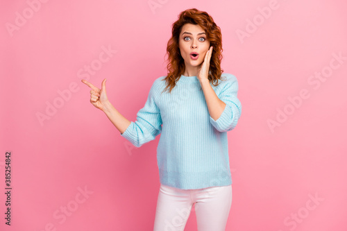 Portrait of her she nice-looking attractive lovely amazed stunned astonished cheerful cheery wavy-haired girl demonstrating ad advert new novelty isolated over pink pastel color background © deagreez