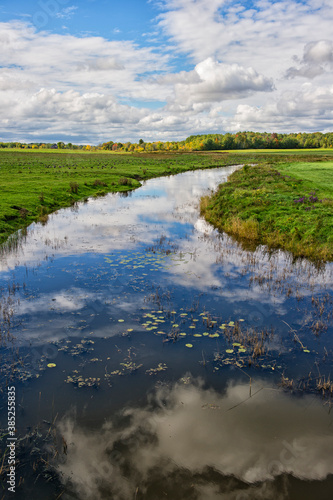 farm field with irrigation and sky reflection