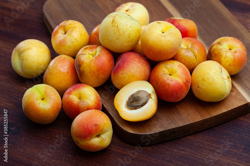 Delicious ripe apricots fruit on wooden surface close up