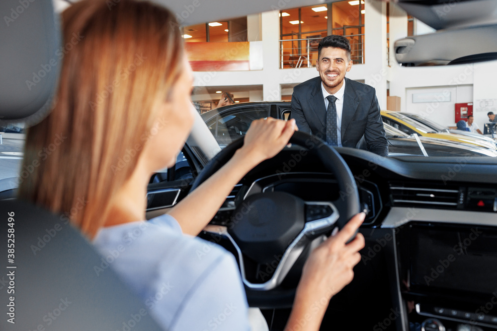 Happy woman new car owner sitting in driver seat Happy woman new car owner sitting in driver seat