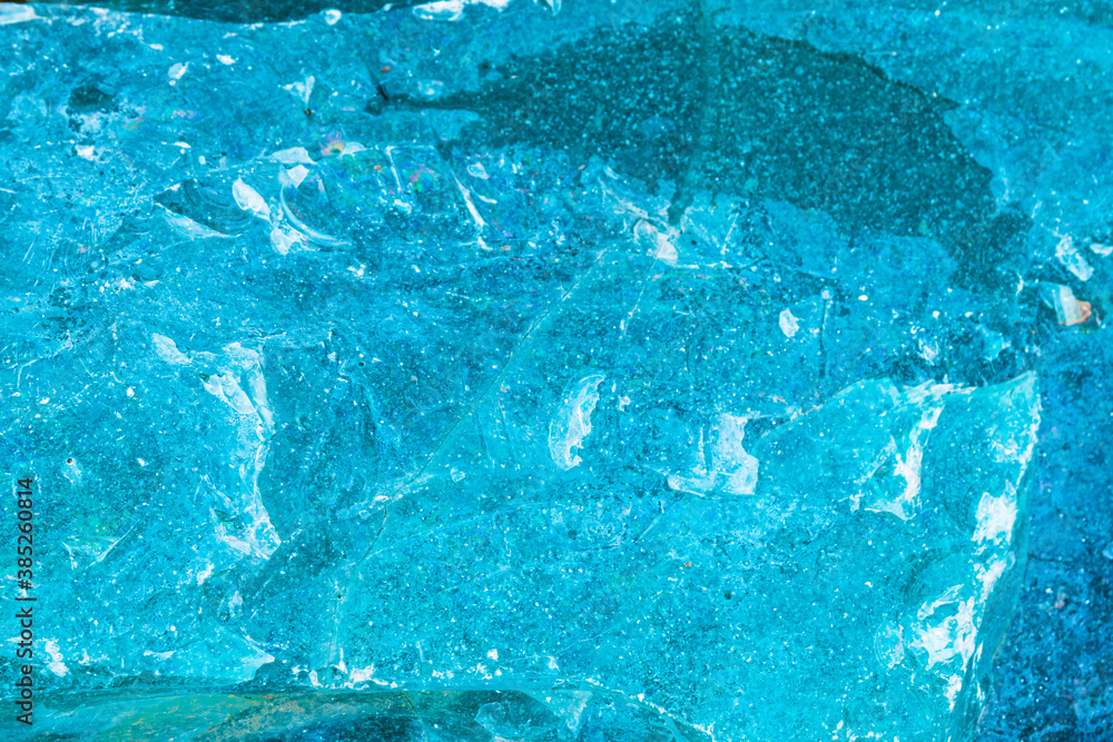 A beautiful turquoise surface of an old glass block. Cobblestone can be used as a background