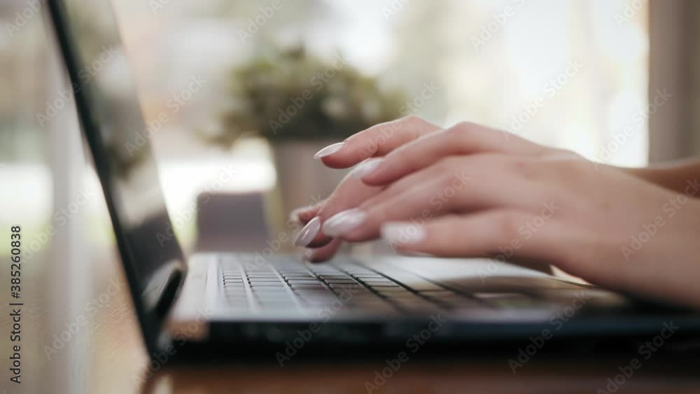 Female hands of business woman using typing on laptop keyboard sitting at home office or coffee shop. Technology concept. Female hands of business woman using typing on laptop keyboard sitting at home office or coffee shop. Technology concept.