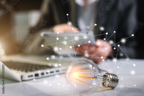 Canvas Print Business women hand showing creative business strategy with light bulb in office