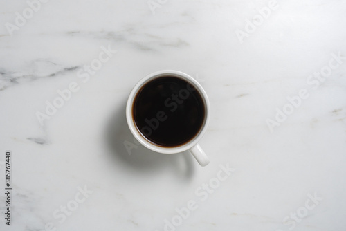 Cup of black coffee on marble