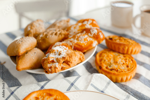 Appetizing rye flour pastries on a table on a linen towel with natural light