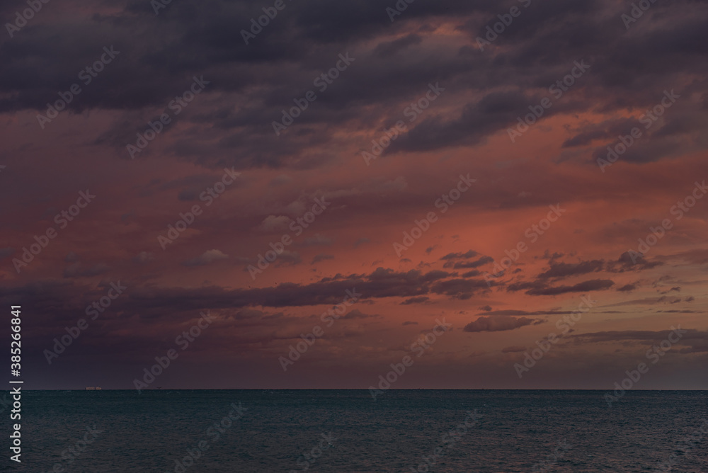 Stormy skies over the sea with varying colours and cloud formations