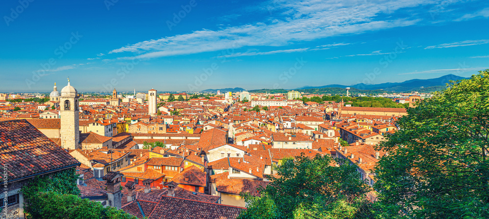 Aerial panoramic view of old historical city centre of Brescia city with churches, towers and medieval buildings with red tiled roofs, Lombardy, Northern Italy. Cityscape of Brescia town.