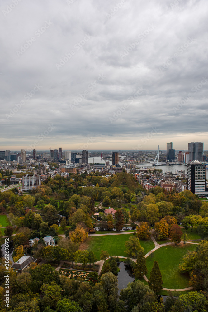 The Rotterdam skyline from the top of the TV Tower, under a grey autumn sky with a park in the foreground 