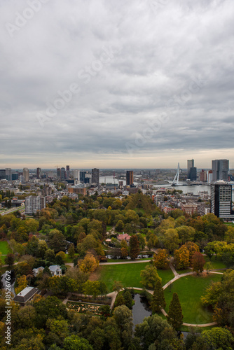 The Rotterdam skyline from the top of the TV Tower  under a grey autumn sky with a park in the foreground 