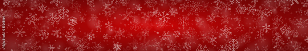 Christmas banner of snowflakes of different shapes, sizes and transparency on red background