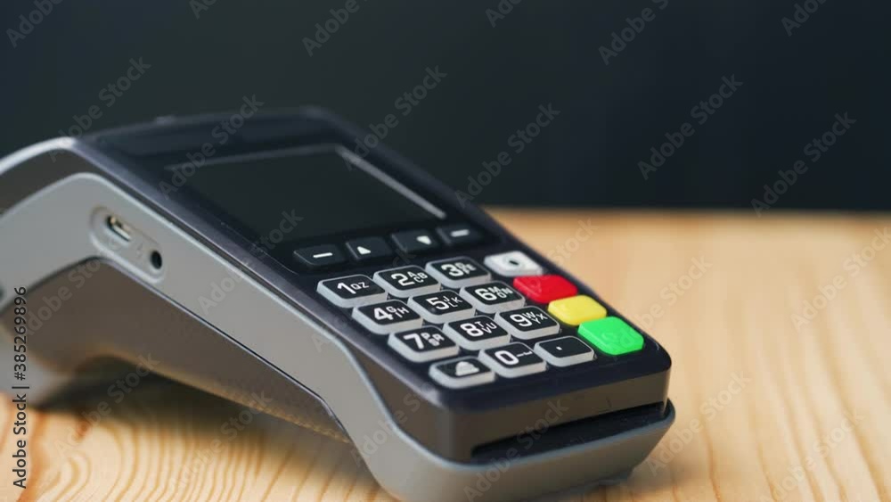 NFC credit card payment. Woman paying with contactless credit card with NFC technology. Wireless money transaction. Wireless payment NFC credit card payment. Woman paying with contactless credit card with NFC technology. Wireless money transaction. Wireless payment