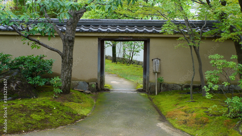 Japanese temple garden with moss, maple trees, gates and bridges