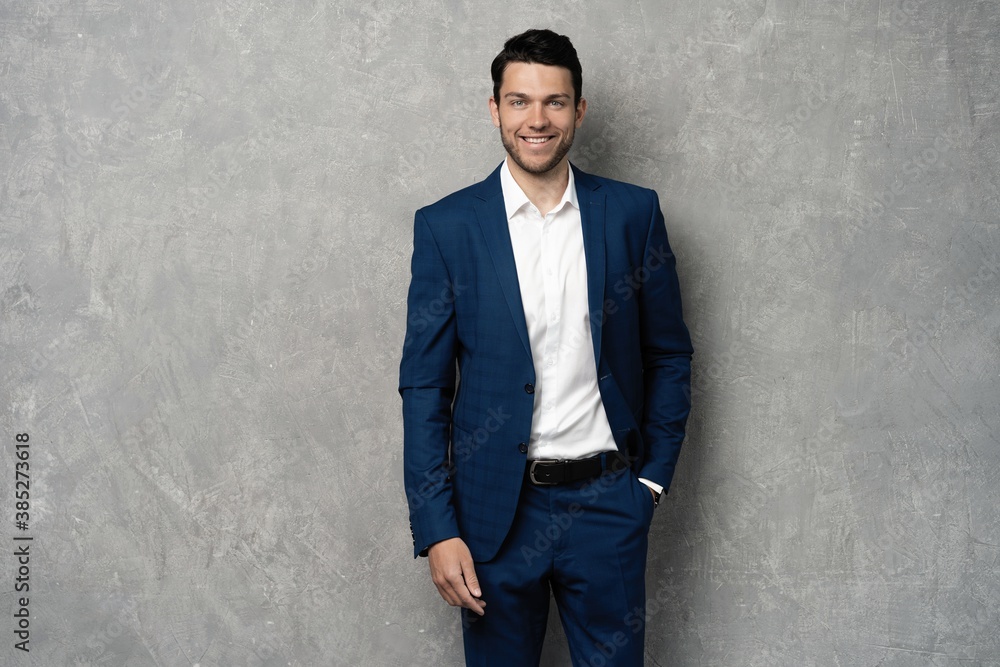 Handsome man wear blue suit isolated on grey background Handsome man wear blue suit isolated on grey background