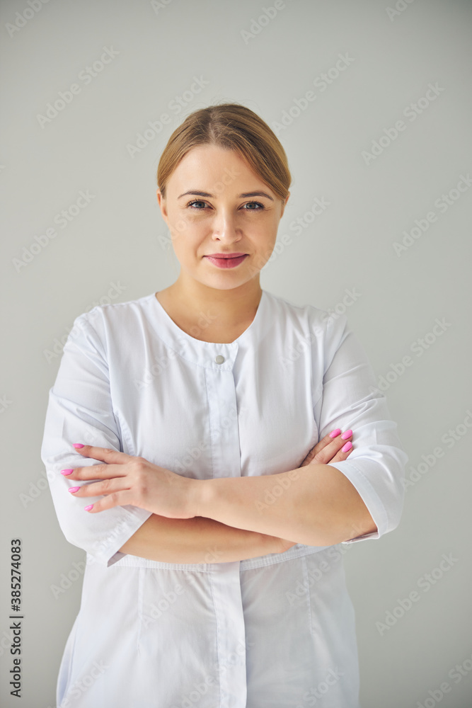 Certified female dermatologist looking at the camera Certified female dermatologist looking at the camera