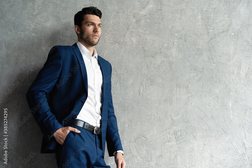 Handsome man wear blue suit isolated on grey background Handsome man wear blue suit isolated on grey background