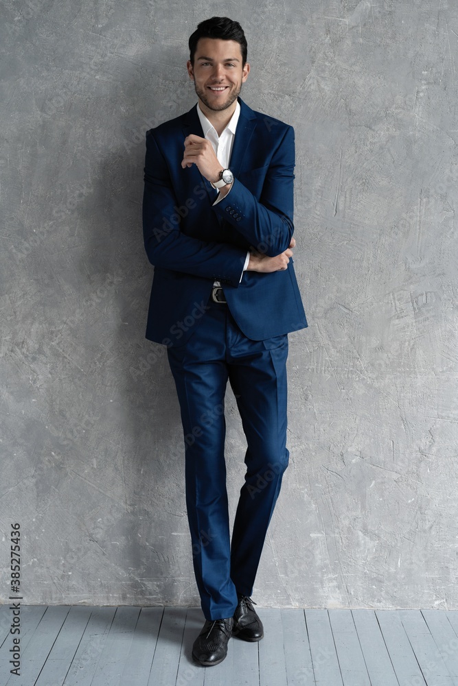 full length of handsome man wear blue suit isolated on grey background full length of handsome man wear blue suit isolated on grey background