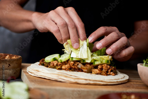 man preparing a durum or a burrito
