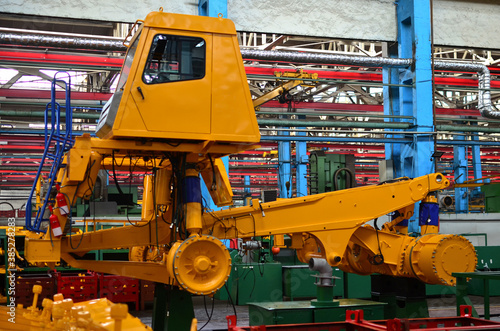 Production process of heavy mining trucks at the factory. Dump truck on the Industrial conveyor in the workshop of an automobile plant. Manufacturer of haulage and earthmoving equipment, haul trucksм