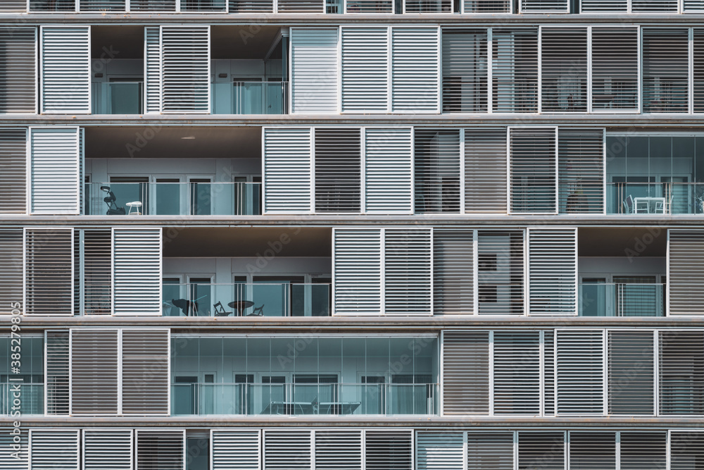 Frontal view of the shutters and balconies of an urban building Frontal view of the shutters and balconies of an urban building