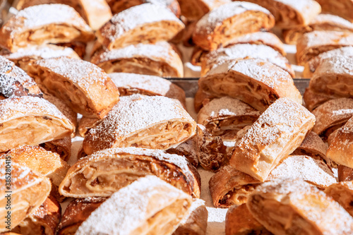 Many pieces of traditional apple strudel at the grocery autumn market  (Selective focus)