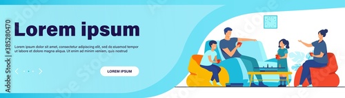 Family home activities concept. Happy boy and girl with parents playing board games with cards and dices in living room. For entertainment, togetherness, having together topics