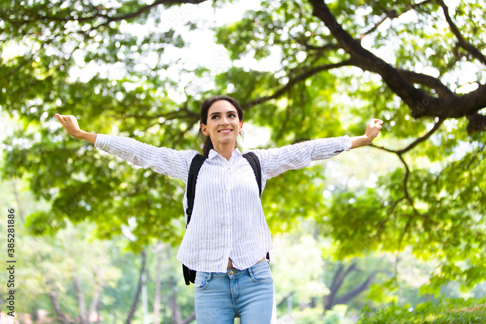Happy freedom woman enjoy nature at green park. Freedome concept. Backpack travel summer Happy freedom woman enjoy nature at green park. Freedome concept. Backpack travel summer
