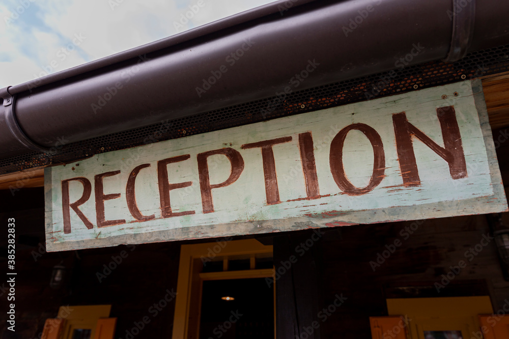 Reception sign made of wood at the Hotel entrance
