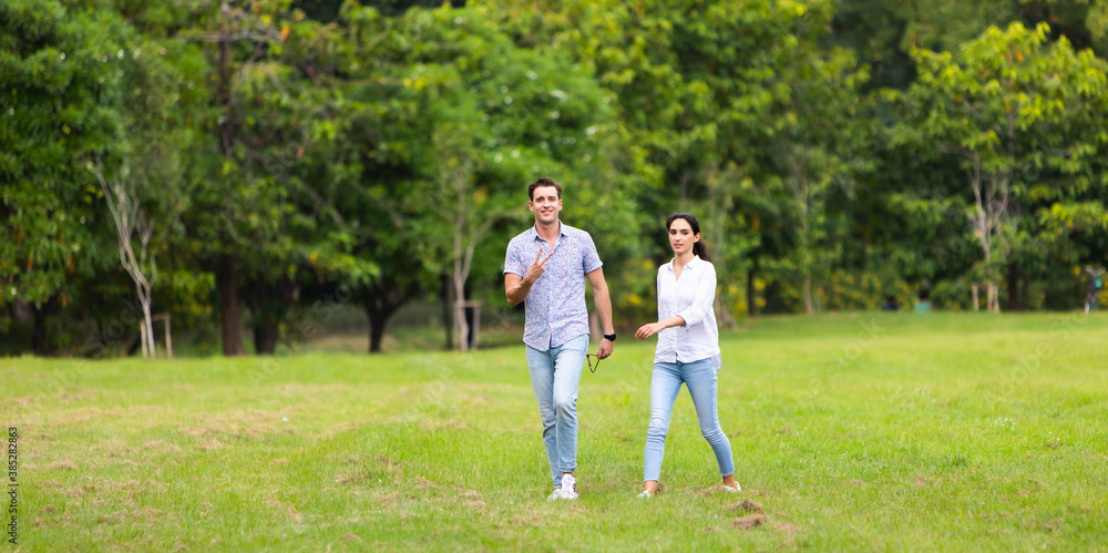 Romantic couple in love concept. Young couple enjoying walking a day at the park Romantic couple in love concept. Young couple enjoying walking a day at the park