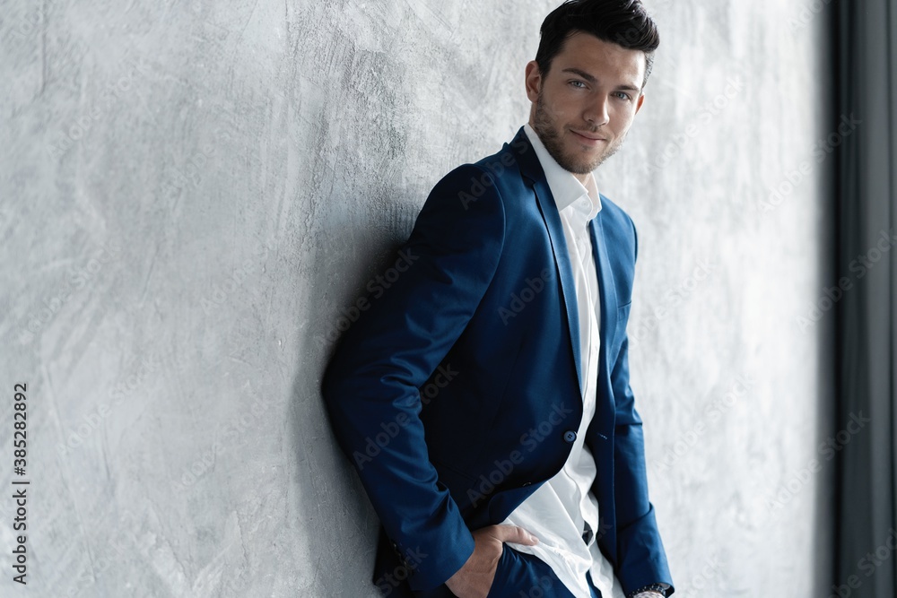 Handsome man wear blue suit isolated on grey background Handsome man wear blue suit isolated on grey background
