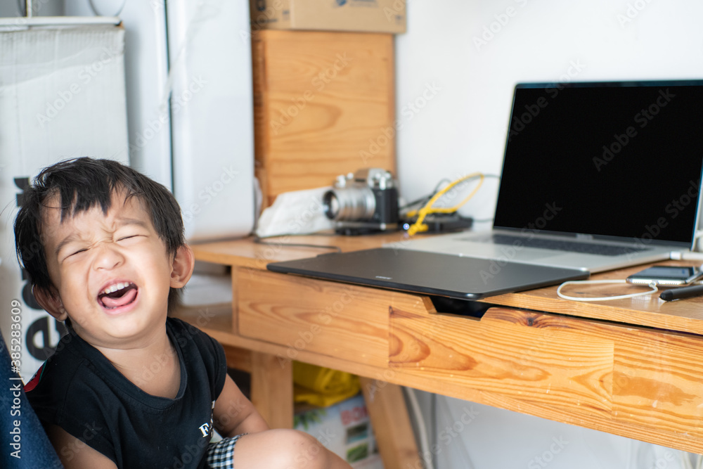 Asian cute 2 year boy using laptop computer sitting on father chair at home. Asian cute 2 year boy using laptop computer sitting on father chair at home.