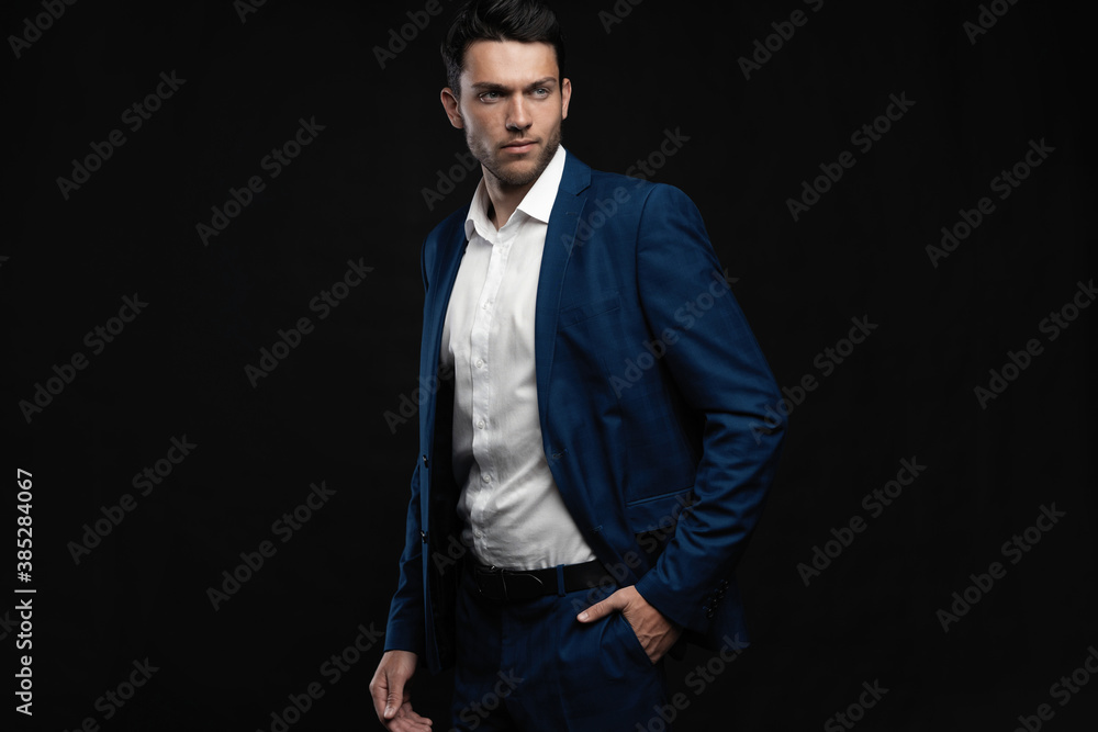Handsome man wear blue suit isolated on black background