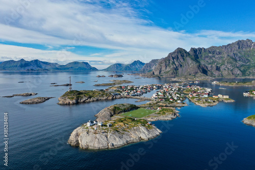 Aerial view of mountains, ocean, lighthouse, city and football field in Lofoten Norway