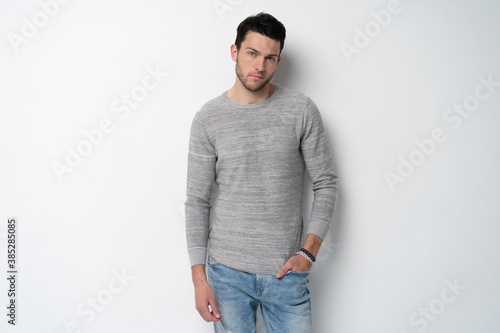 Handsome young man on white background looking at camera. Happy guy smiling.
