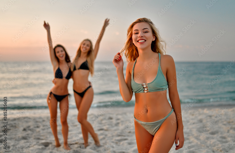 Girls in swimsuits on the beach