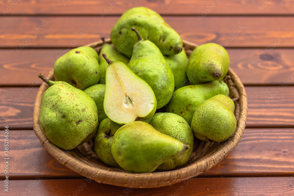 Bio sweet fresh pears from the farm. Healthy Organic Pears in the Basket on wooden rustic background. Healthy food full of vitamins. Pear harvest.Autumn nature concept. Tasty vegetarian snack. Bio sweet fresh pears from the farm. Healthy Organic Pears in the Basket on wooden rustic background. Healthy food full of vitamins. Pear harvest.Autumn nature concept. Tasty vegetarian snack.