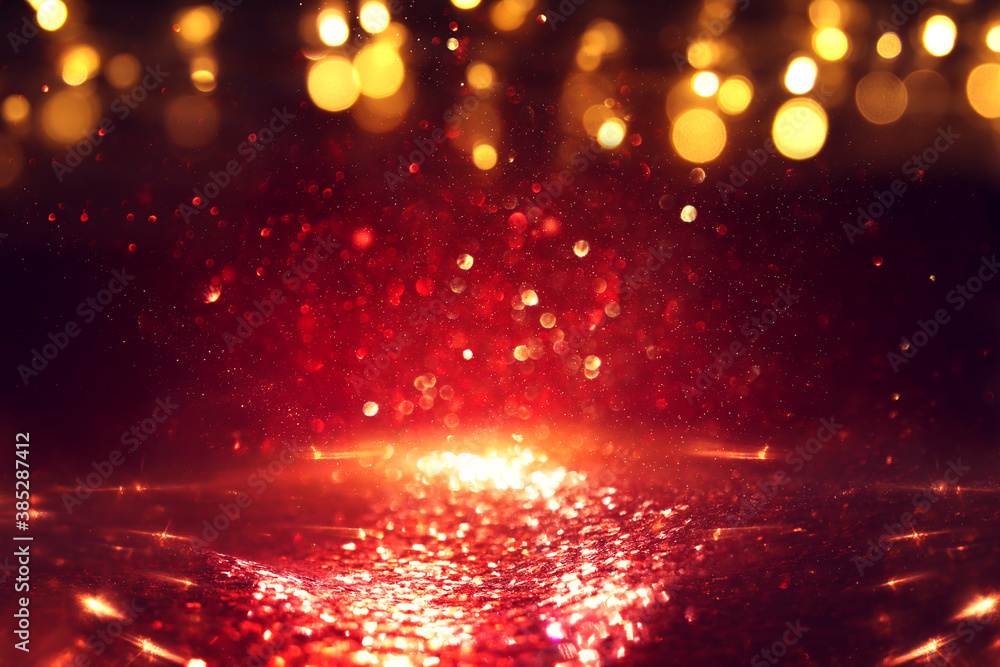 Fototapeta premium background of abstract red, gold and black glitter lights. defocused