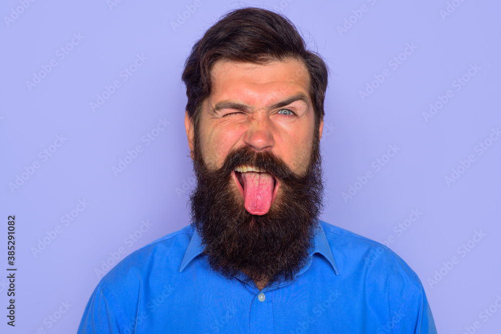 Obraz premium Man shows tongue. People emotions. Face expression. Fanny man.