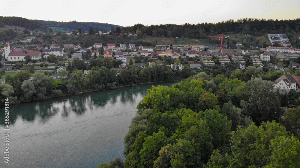 Aerial view over Aare river, the train bridge of Brugg and residential area of Umikenand Riniken, Switzerland.