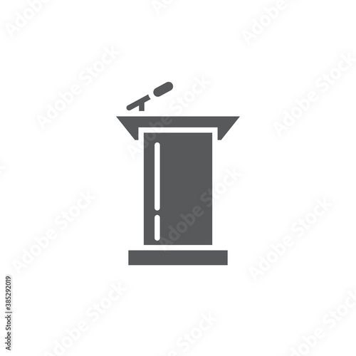 Podium with microphone vector icon symbol isolated on white background