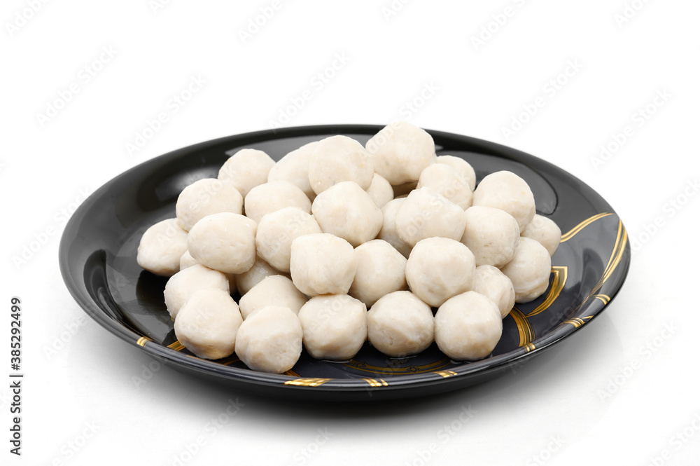 Meat or fish ball placed in a black plate isolated on white background Meat or fish ball placed in a black plate isolated on white background