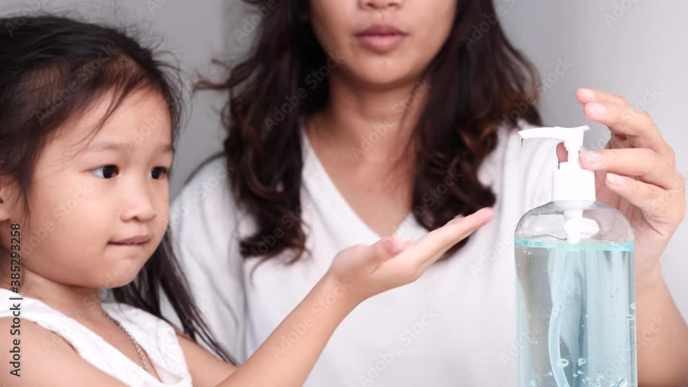 Young mother and little child girl using hand sanitizer alcohol gel pump dispenser antibacterial antiseptic washing hand to prevent spreading virus, Selective focus and slow motion. Coronavirus COVID- Young mother and little child girl using hand sanitizer alcohol gel pump dispenser antibacterial antiseptic washing hand to prevent spreading virus, Selective focus and slow motion. Coronavirus COVID-